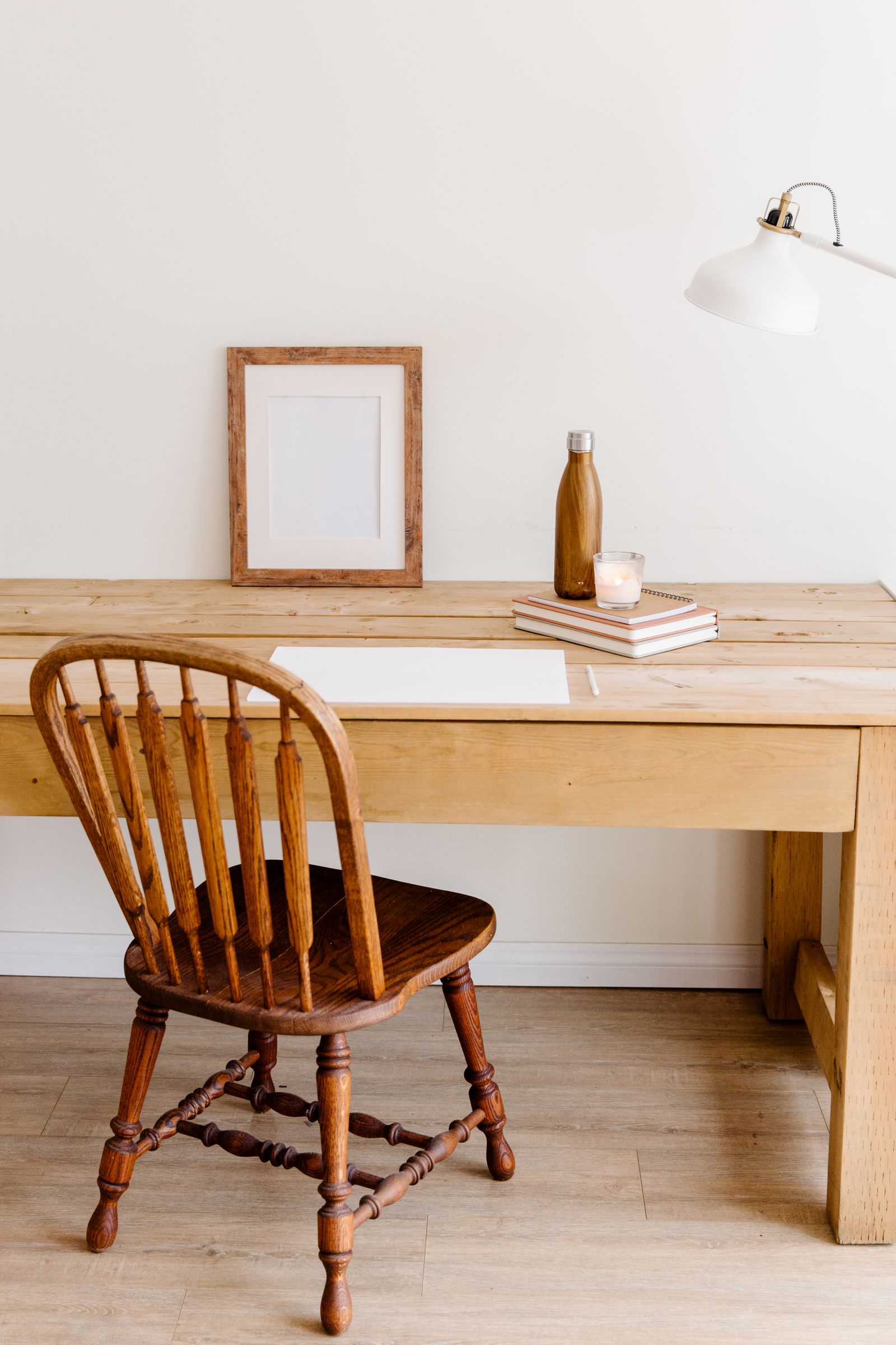 A plank-top ash writing desk with a Windsor chair