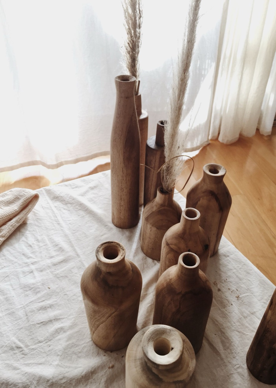 A slender wooden bud vase